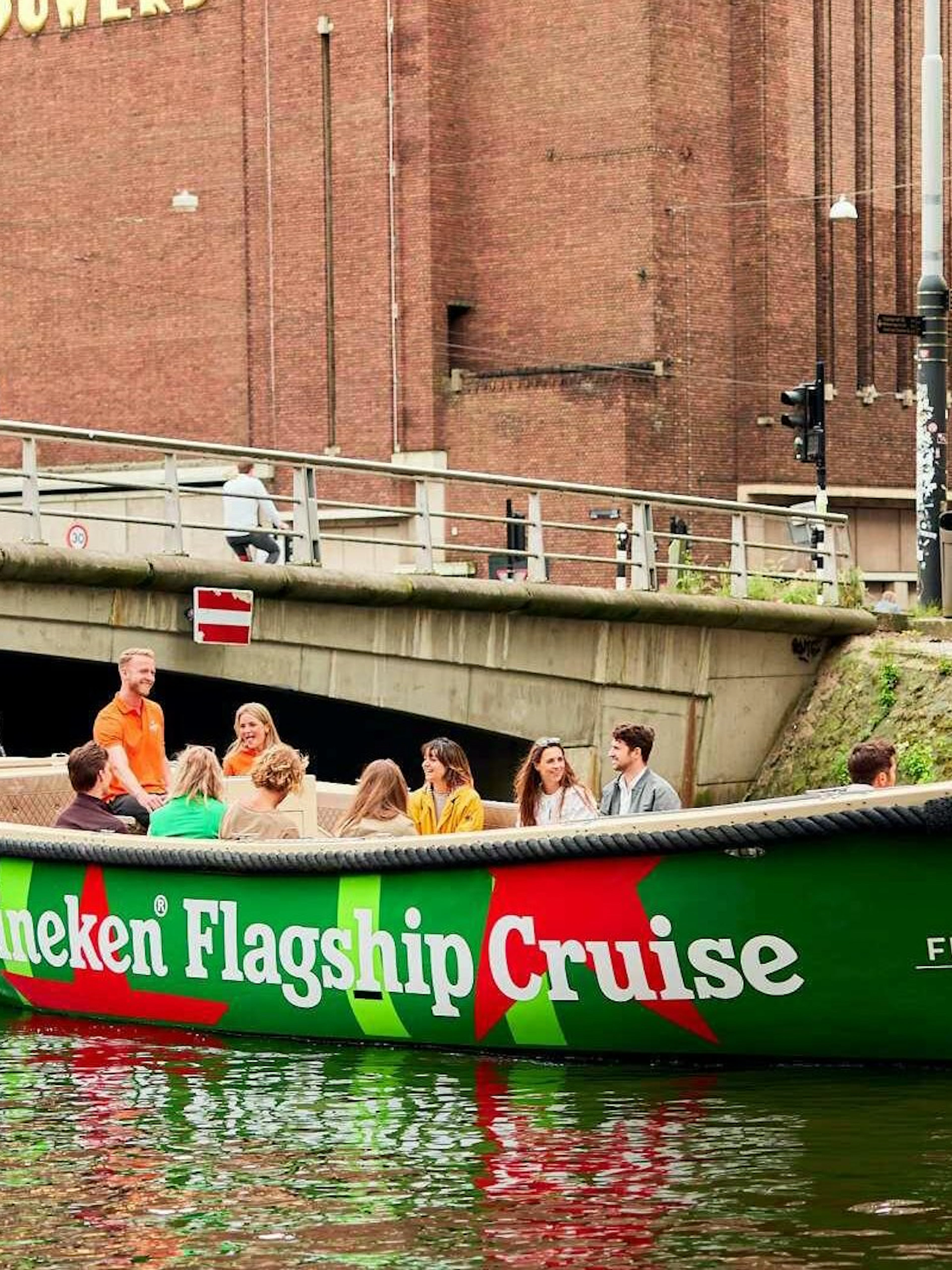 Guests enjoying Heineken Flagship Cruise on Amsterdam canal.