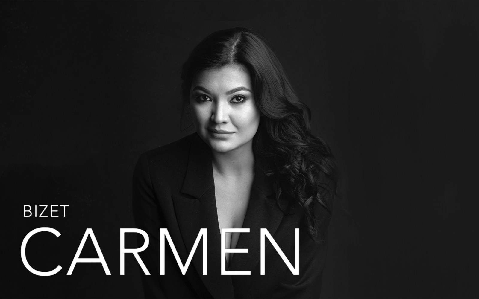 Bizet's Carmen promotional image with a woman in a dark outfit.