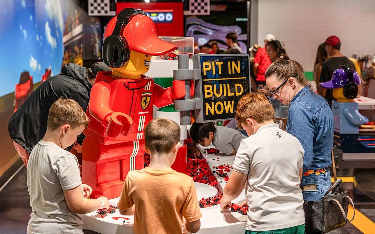 Children building LEGO cars at Ferrari Build and Race Test Zone, LEGOLAND Florida.