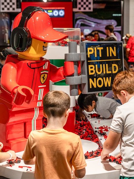 Children building LEGO cars at Ferrari Build and Race Test Zone, LEGOLAND Florida.