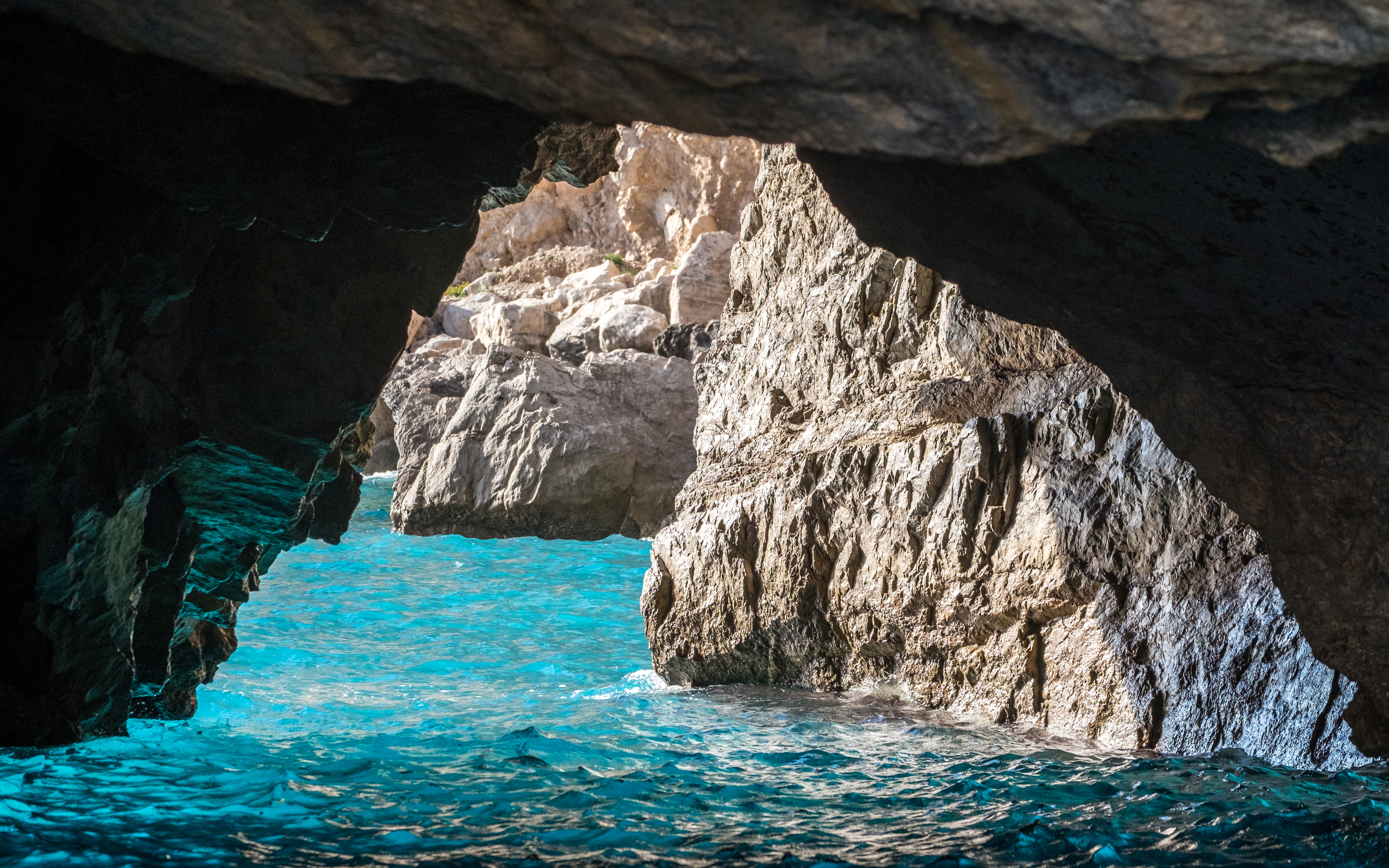 The Green Grotto's turquoise waters and rocky cave entrance in Capri, Italy.