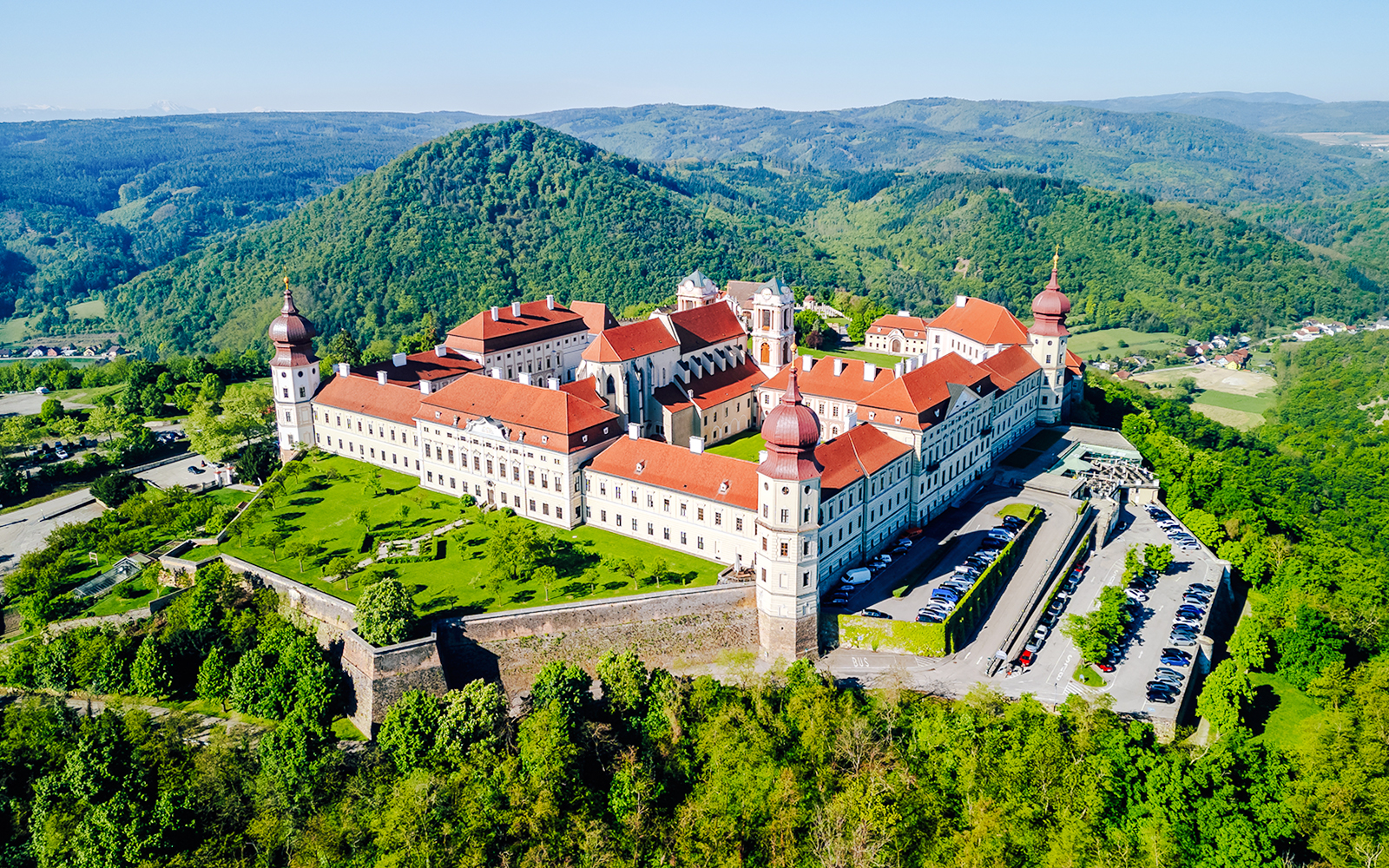 Aerial view of Göttweig Abbey surrounded by lush green hills in Austria.