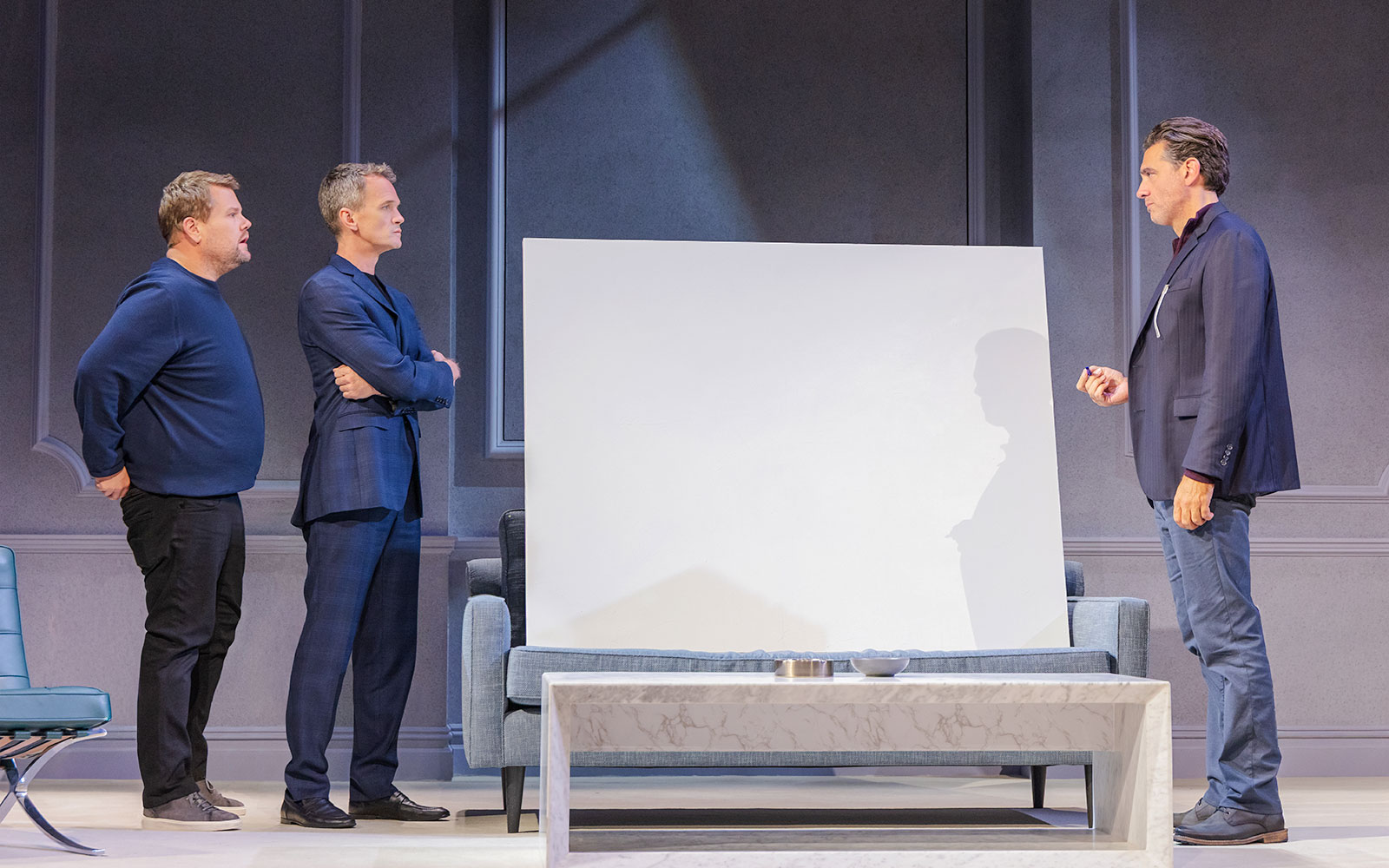 Three actors on stage during a scene from the Art Broadway show.