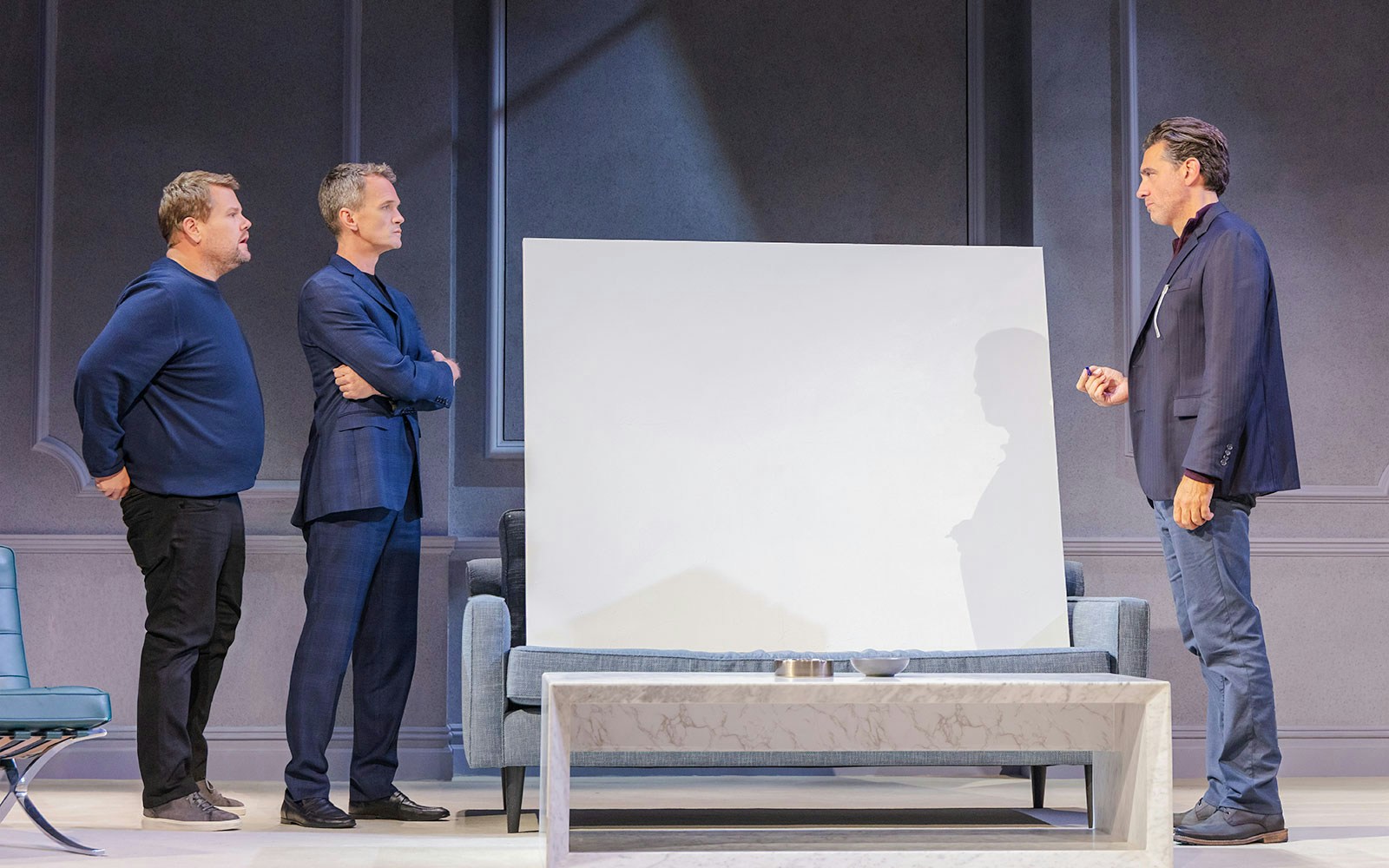 Three actors on stage during a scene from the Art Broadway show.