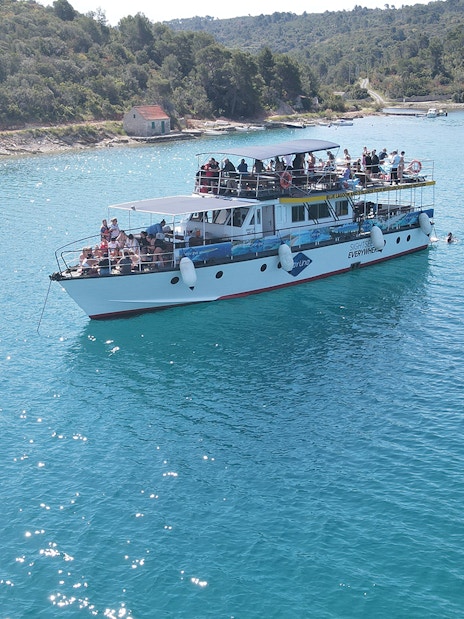 Cruise ship on Blue Lagoon near Split with passengers enjoying the view.