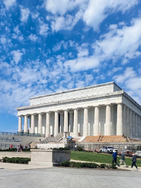Lincoln Memorial with visitors in Washington D.C. under a clear blue sky.