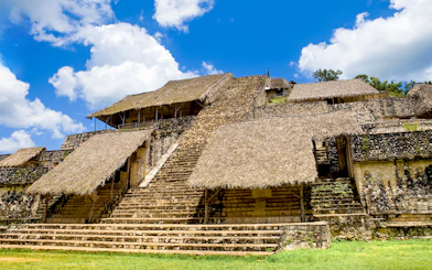 Ancient Mayan pyramid with thatched roofs at Ek Balam, Mexico.