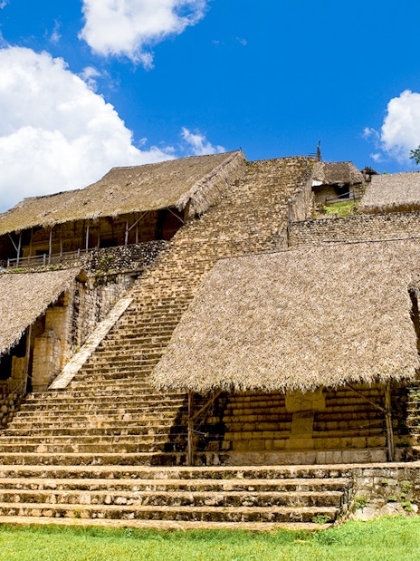 Ancient Mayan pyramid with thatched roofs at Ek Balam, Mexico.