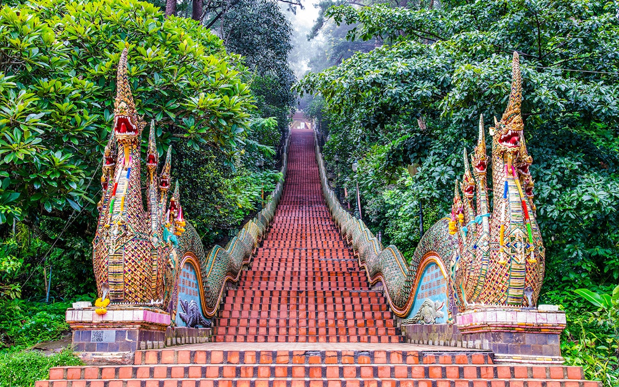 Naga-flanked staircase ascending to Wat Phra That Doi Suthep, Chiang Mai, Thailand.