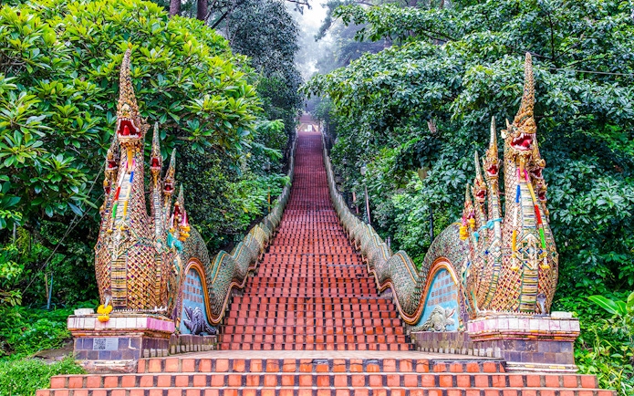Naga-flanked staircase ascending to Wat Phra That Doi Suthep, Chiang Mai, Thailand.