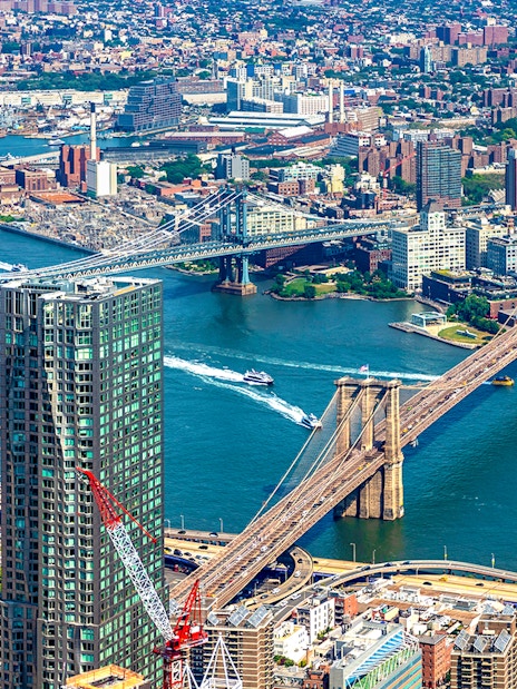 Aerial view of Brooklyn Bridge spanning East River in New York City.
