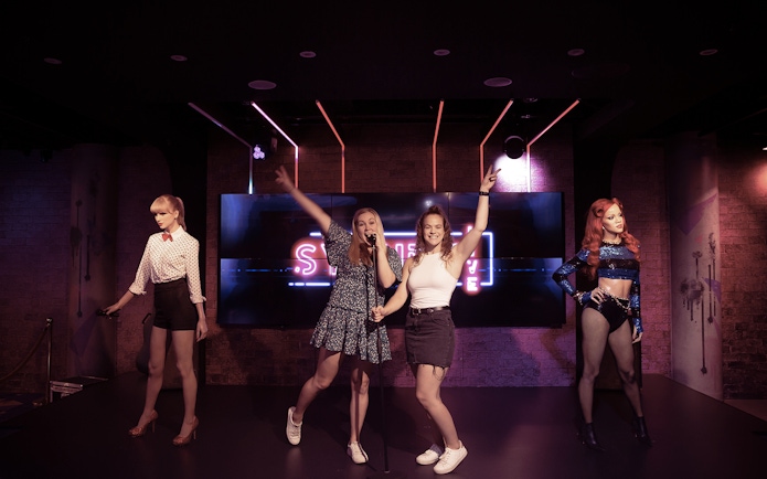 Visitors posing with wax figures at Madame Tussauds Sydney.