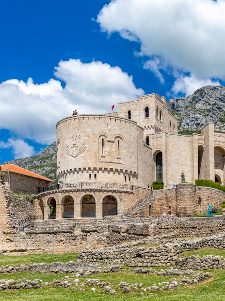 Kruja Castle with stone walls and mountainous backdrop in Albania.