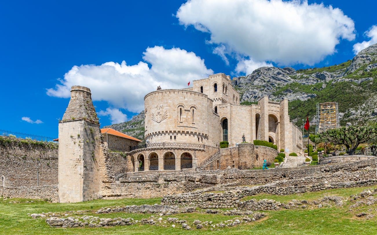 Kruja Castle with stone walls and mountainous backdrop in Albania.