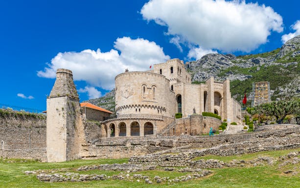 Kruja Castle with stone walls and mountainous backdrop in Albania.