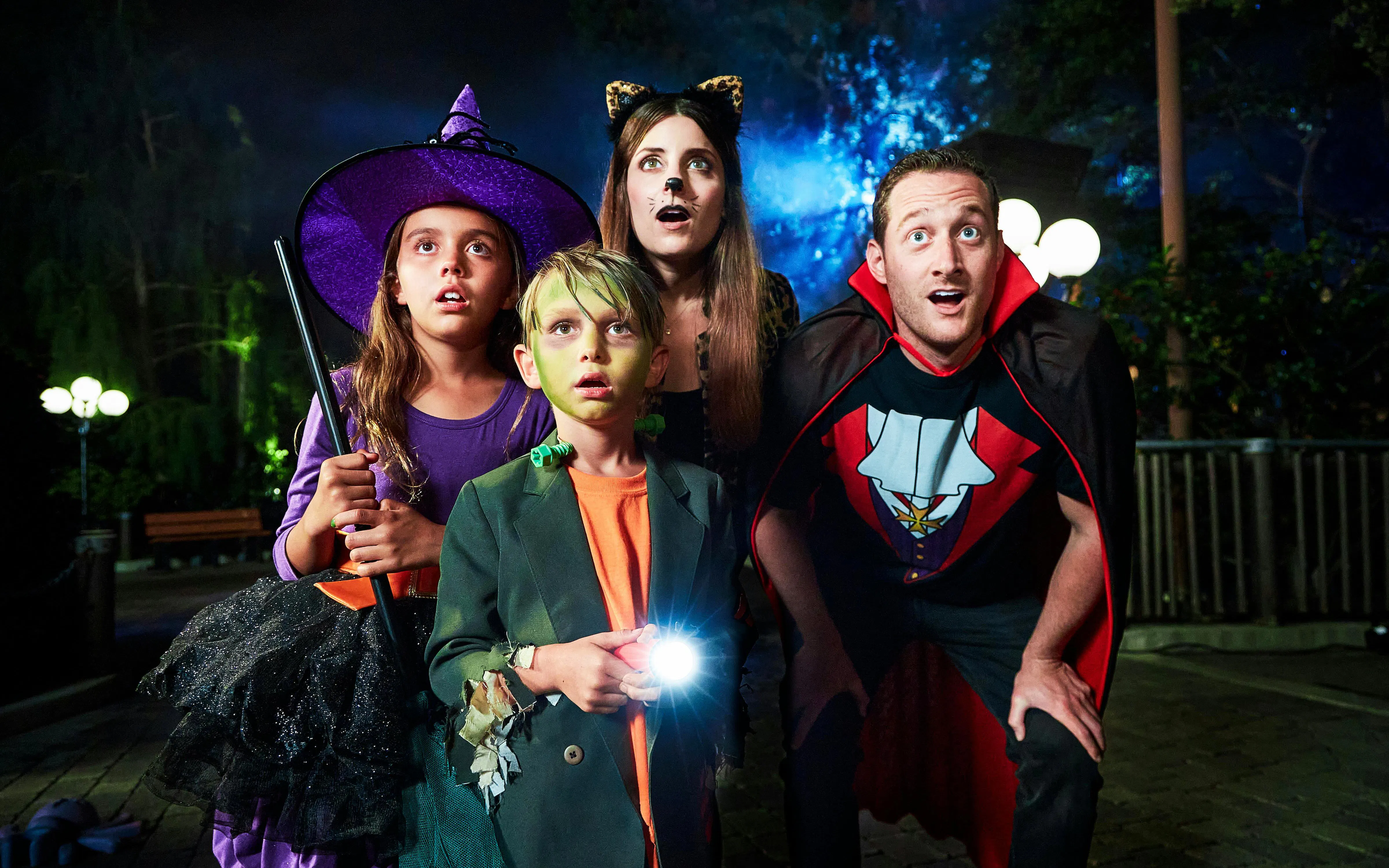 Children and adults in Halloween costumes at Legoland New York Halloween event.