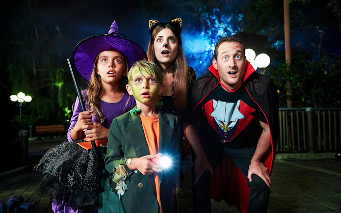 Children and adults in Halloween costumes at Legoland New York Halloween event.