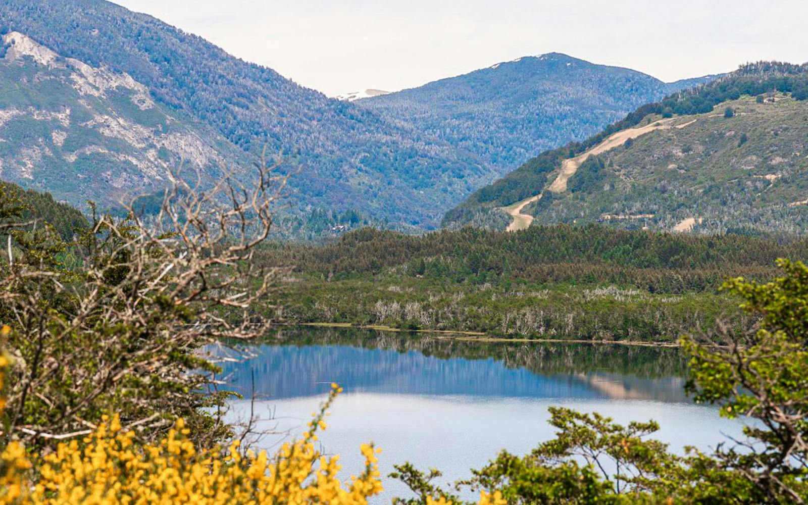 Mountain landscape reflected in a lake along the Seven Lakes Route.