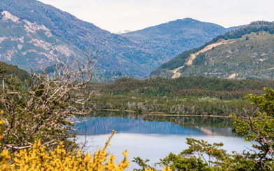 Mountain landscape reflected in a lake along the Seven Lakes Route.