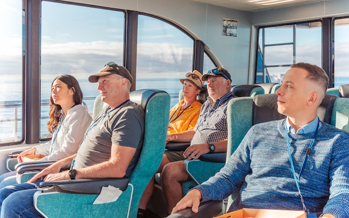 Passengers seated inside a boat during a whale watching cruise in Kaikoura.