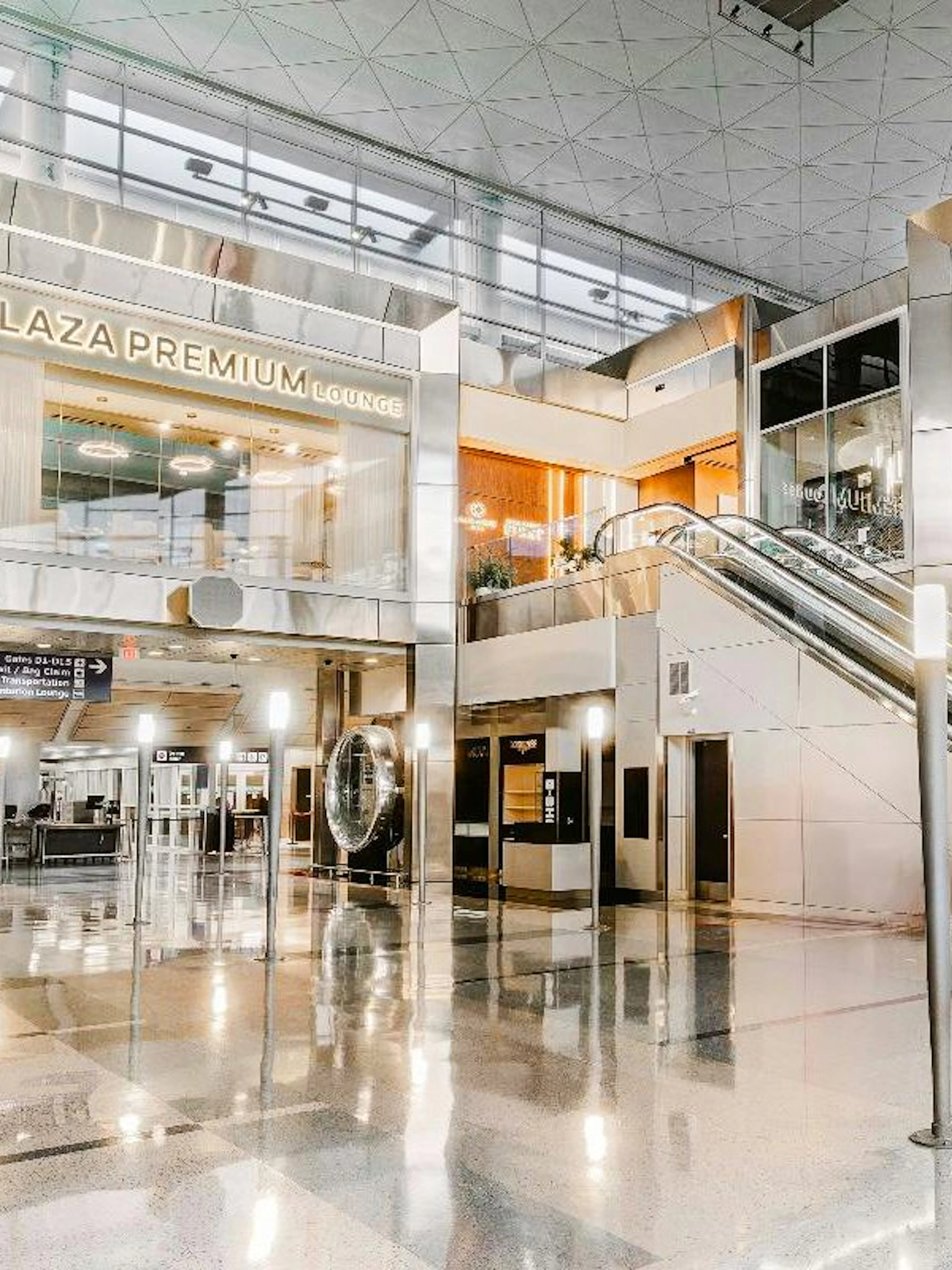Plaza Premium Lounge entrance at Dallas Fort Worth International Airport with escalator.