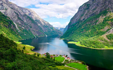 Flåm village nestled between mountains and Aurlandsfjord in Western Norway.