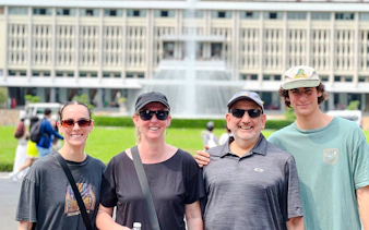 Tourists in front of Independence Palace fountain, Saigon, Ho Chi Minh City.