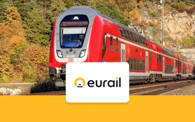 Red train on tracks in Germany with Eurail logo, promoting German Continuous Pass for 2nd class seats.