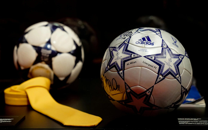 Soccer ball with AC Milan and Liverpool FC logos at Casa Milan Museum, Italy.