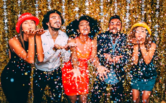 Guests celebrating with confetti on New Year’s Eve cruise in NYC.