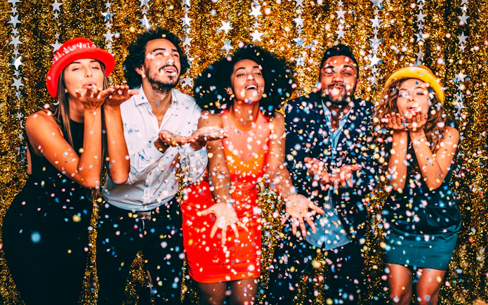 Guests celebrating with confetti on New Year’s Eve cruise in NYC.
