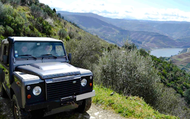 4x4 Jeep on mountain trail with scenic view of Douro Valley, Porto.