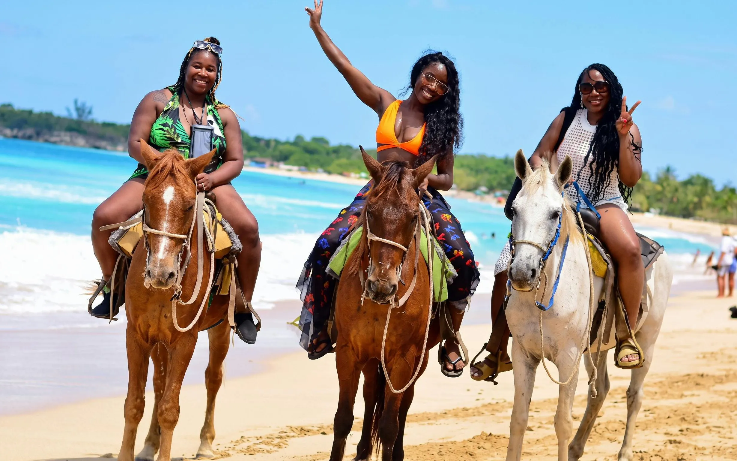 Horseback riding on Macao Beach with ocean view in the background.