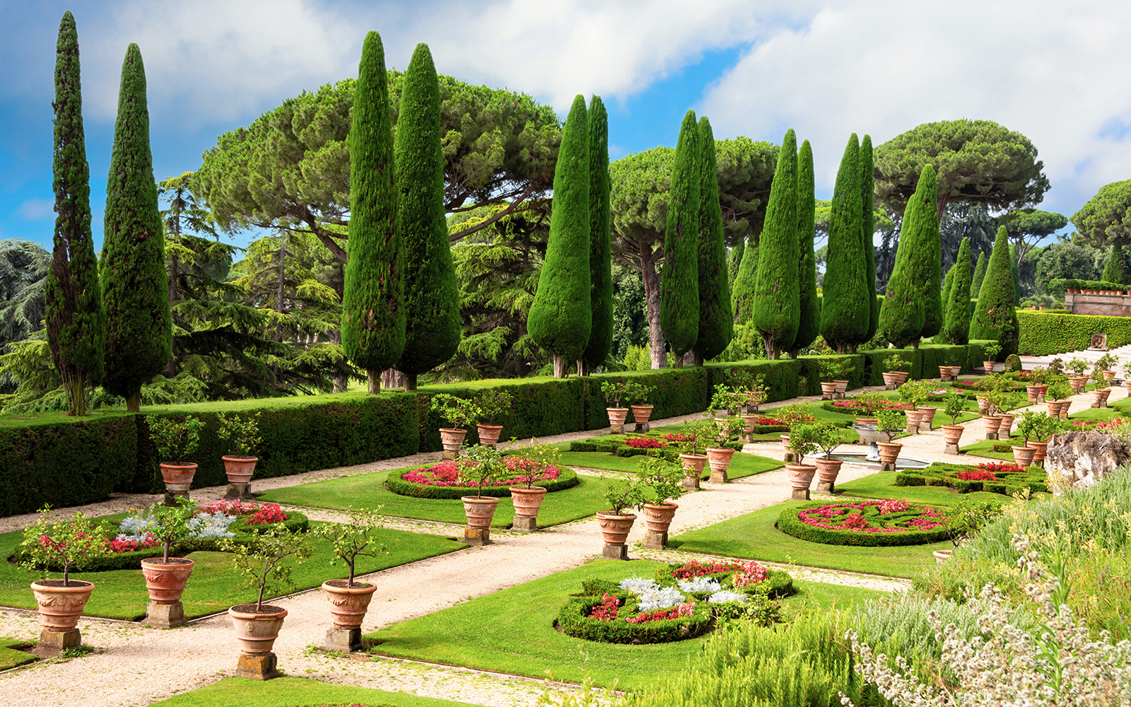 Pontifical Villa Gardens at Castel Gandolfo with manicured paths and cypress trees.