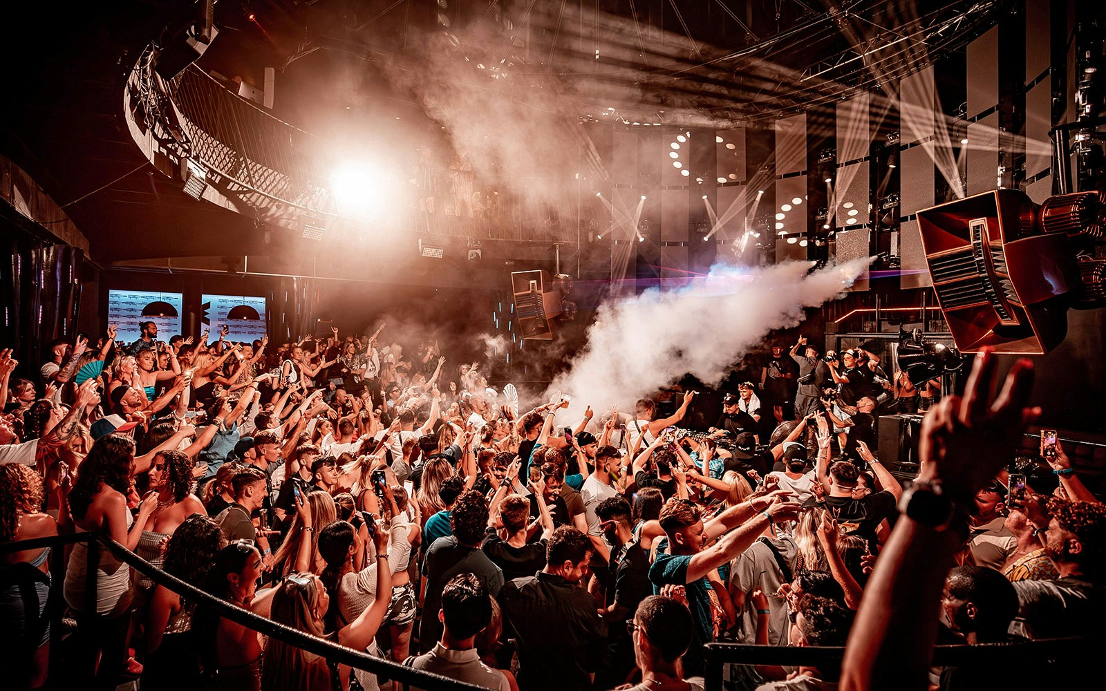 Crowd enjoying a vibrant night at Eden nightclub with lights and music, Ibiza.