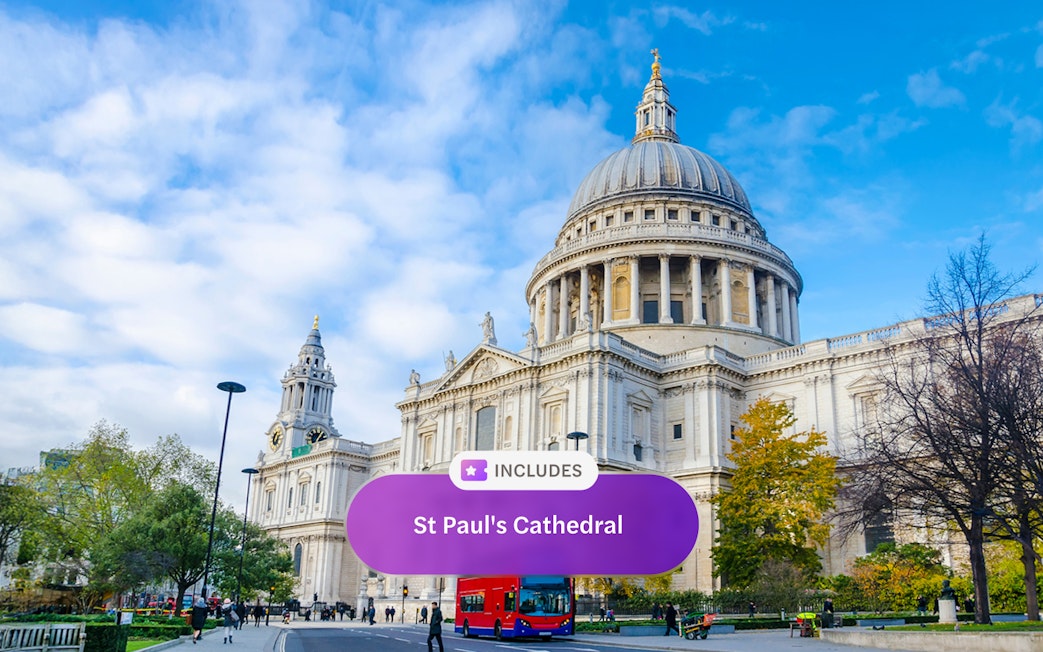 St. Paul's Cathedral in London with a red double-decker bus in front.