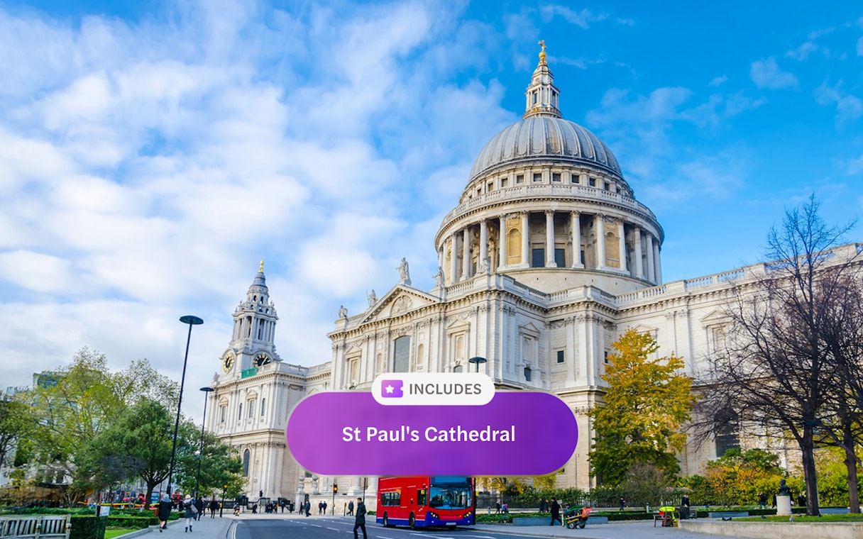 St. Paul's Cathedral in London with a red double-decker bus in front.