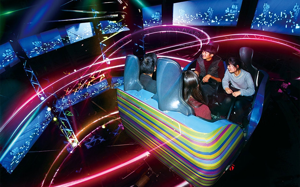 Visitors enjoying a colorful ride at Yomiuriland amusement park in Tokyo.