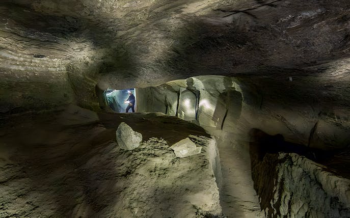 Underground passage in Bochnia Salt Mine with a person exploring.