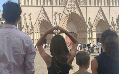 Visitors in front of Lyon Cathedral during a self-guided murder mystery game.