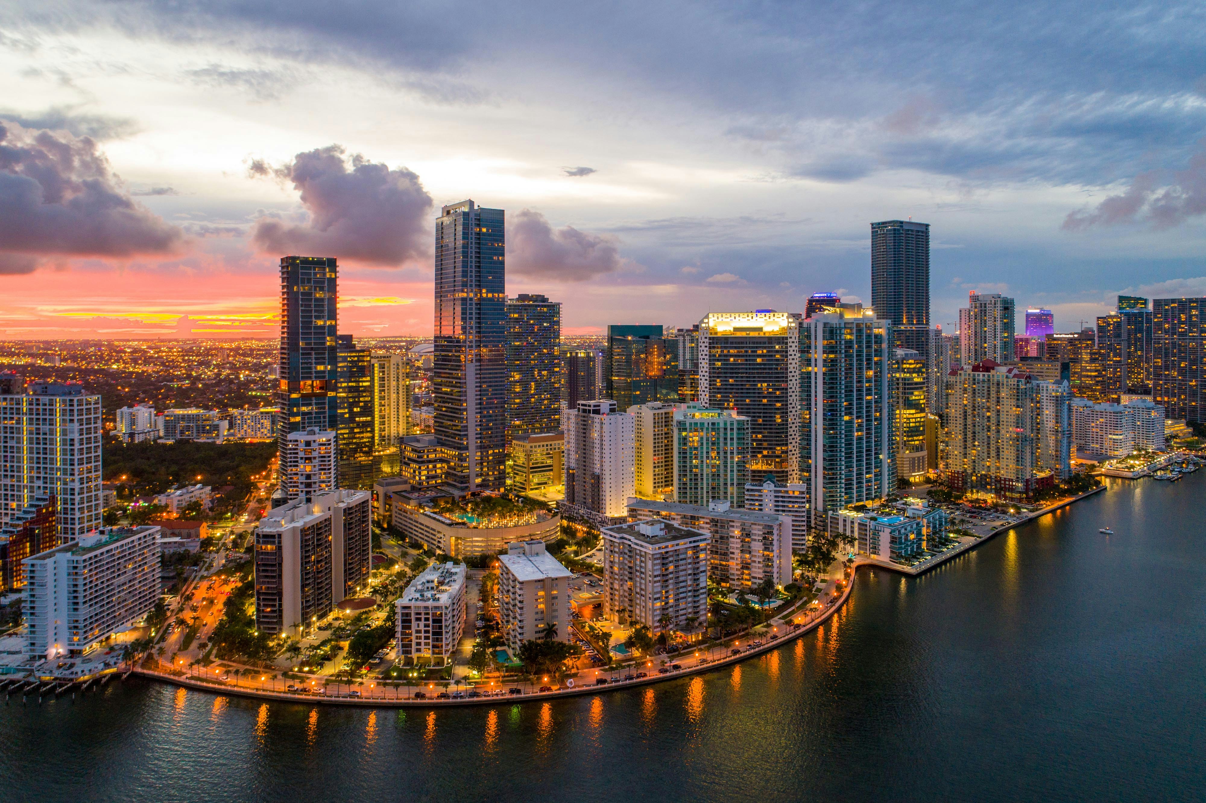 Miami skyline with high-rise buildings and Biscayne Bay in the foreground.