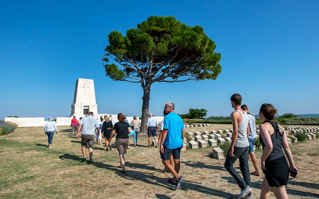 Visitors walking towards a memorial on the Gallipoli Peninsula tour from Istanbul.