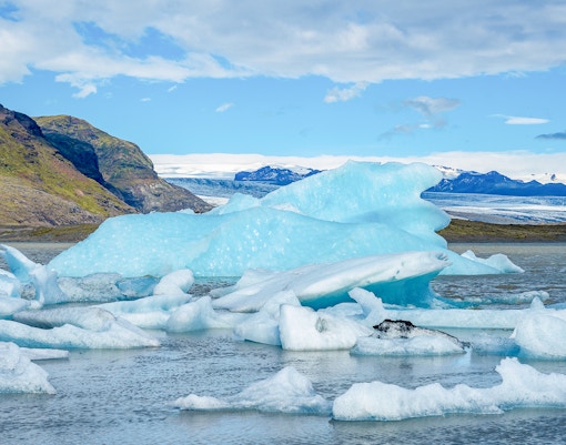 Glacier near Vatnajökull, Iceland, with icy formations and snow-covered peaks.