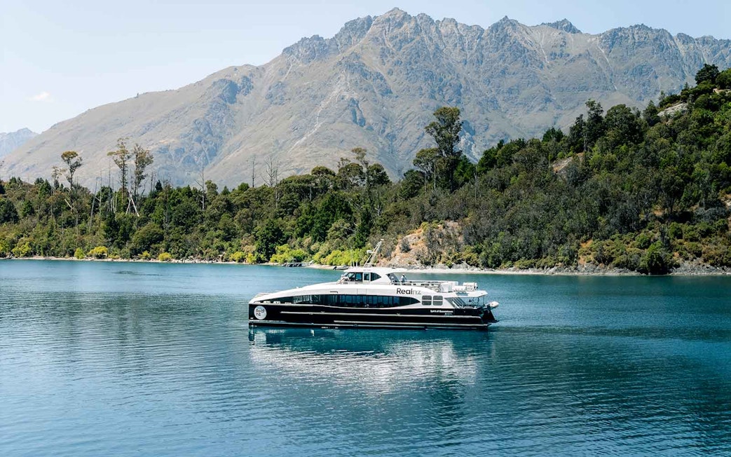 Cruise boat on Lake Wakatipu with mountains in the background, Queenstown, New Zealand.