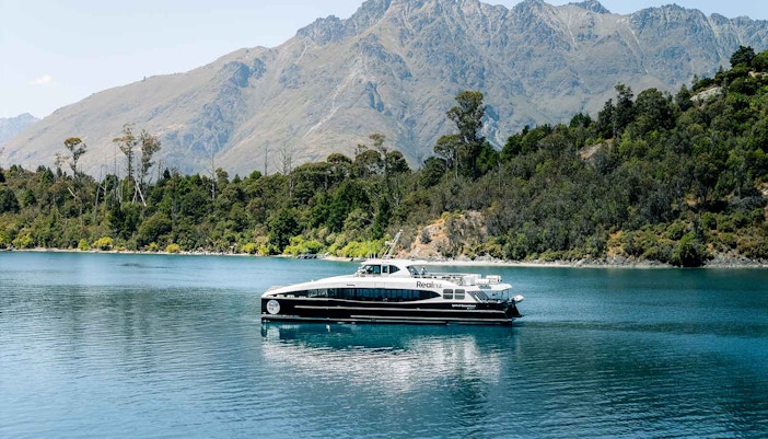 Cruise boat on Lake Wakatipu with mountains in the background, Queenstown, New Zealand.