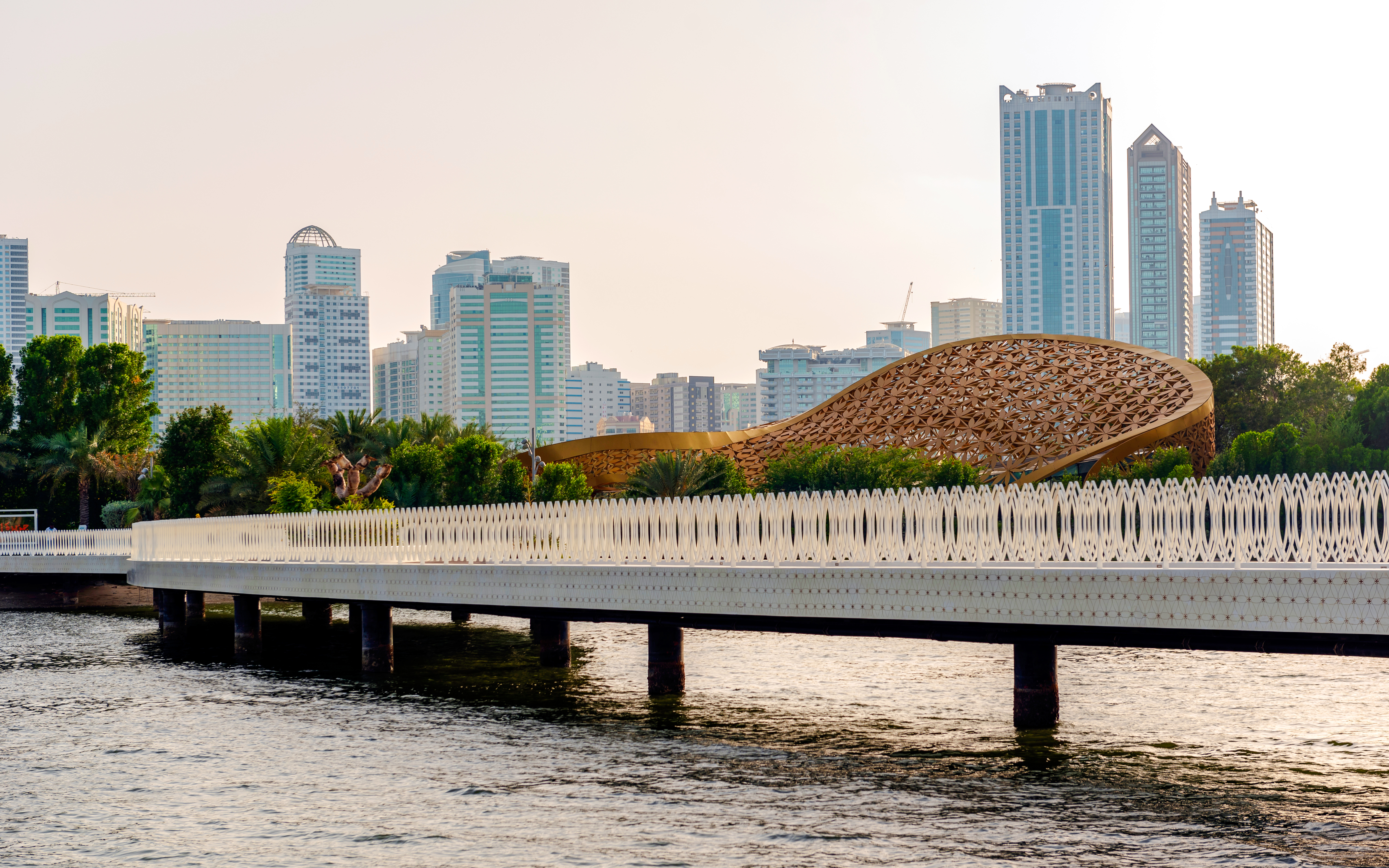 Bridge leading to Al Noor Island with Sharjah skyline in the background.