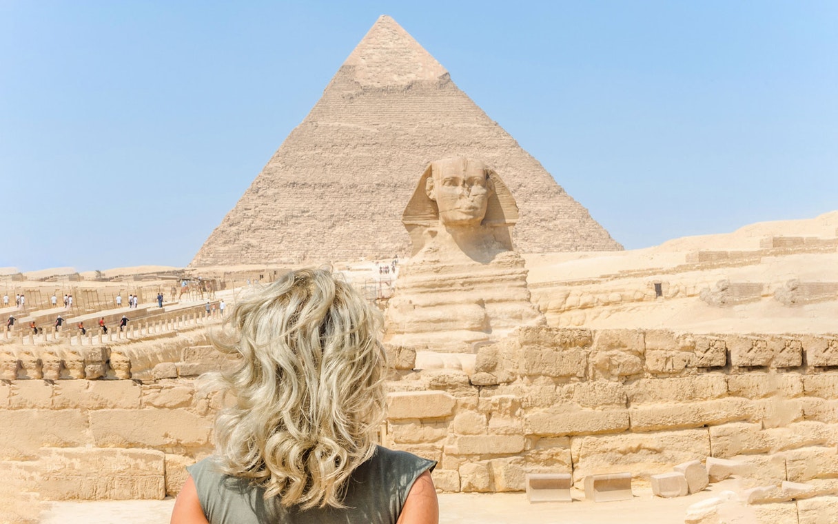 Tourist viewing the Sphinx and Pyramid of Giza in Egypt.