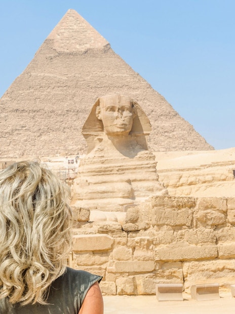 Tourist viewing the Sphinx and Pyramid of Giza in Egypt.