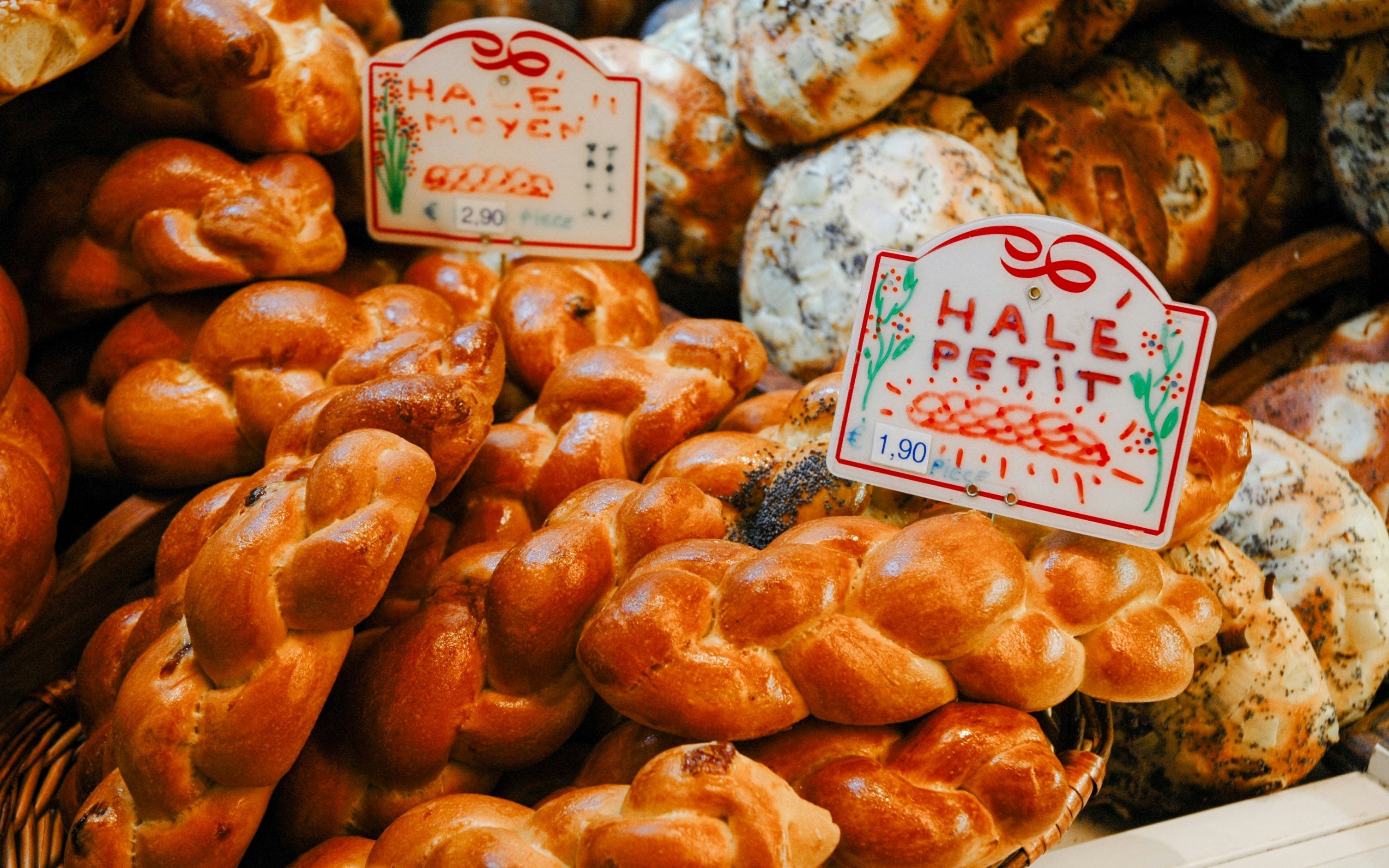 Challah bread display in Jewish Quarter, Paris bakery.