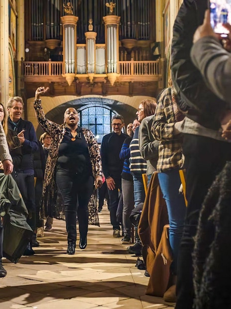 Orchestra performance in St Sulpice Church with audience capturing the moment.